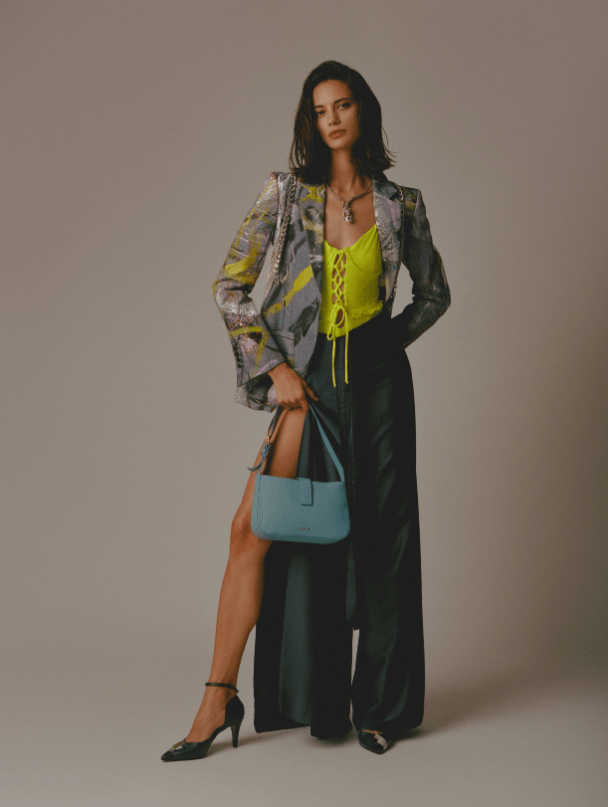Model showcasing EVEN's Valenta Blue Mini Handbag with vibrant outfit in stylish pose.