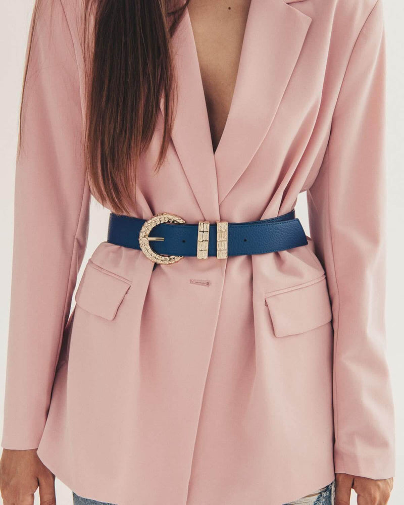 Pink blazer with a blue belt and gold buckle on a plain background