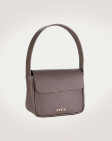 A brown leather mini handbag with a sleek and minimalist design, featuring a small brand logo.