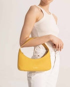 Model wearing ZOE yellow mini baguette bag - sustainable fashion accessory"