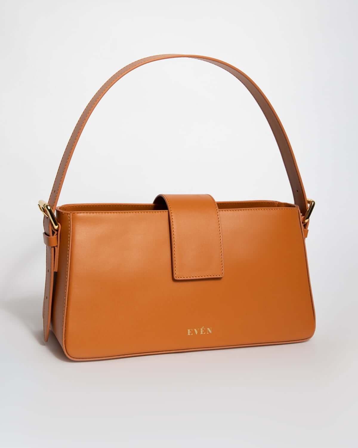 Mini rectangular tote handbag in cognac color with magnetic closure. Crafted from genuine calfskin leather. 