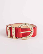 A red leather belt with a gold ornate buckle on a white background.