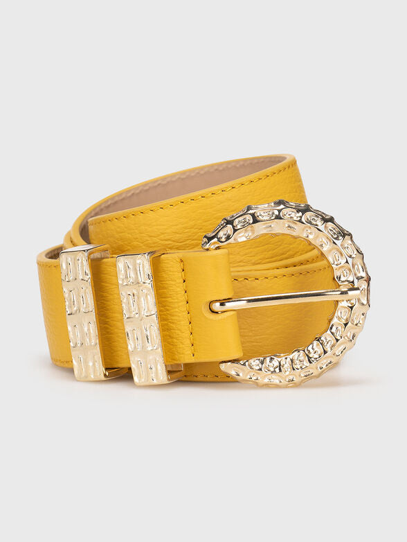Yellow belt with a decorative gold buckle on a light gray background