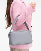 Model showing front view of Rhea messenger bag by even-online.