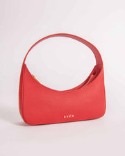 Zoe red calf leather mini baguette bag with a curved zip closure and a brand logo visible on the bottom corner.