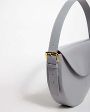 Grey leather mini bag with adjustable strap and gold buckle detail