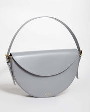 A grey GAIA Mini Bag leather with a sleek and elegant design featuring a shoulder strap, displayed against a plain background.