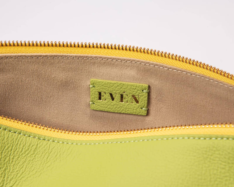 leyza green leather clutch interior with even brand logo 