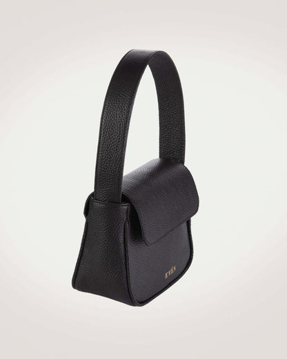 Side picture of the design of mini black leather flap handbag with gold tone logo of even brand.