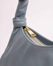 Monna mini handbag in light blue leather with gold zipper and twisted leather handle