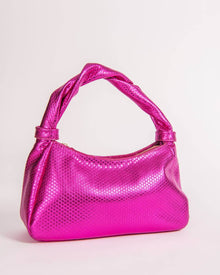 Pink Monna handbag with textured surface on a light pink background