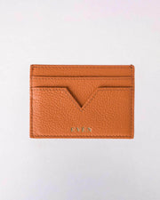 Orange leather cardholder with 'EVEN' branding on a white background