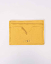 A yellow Muzi brand cardholder made from calfskin leather, displayed on a white background.