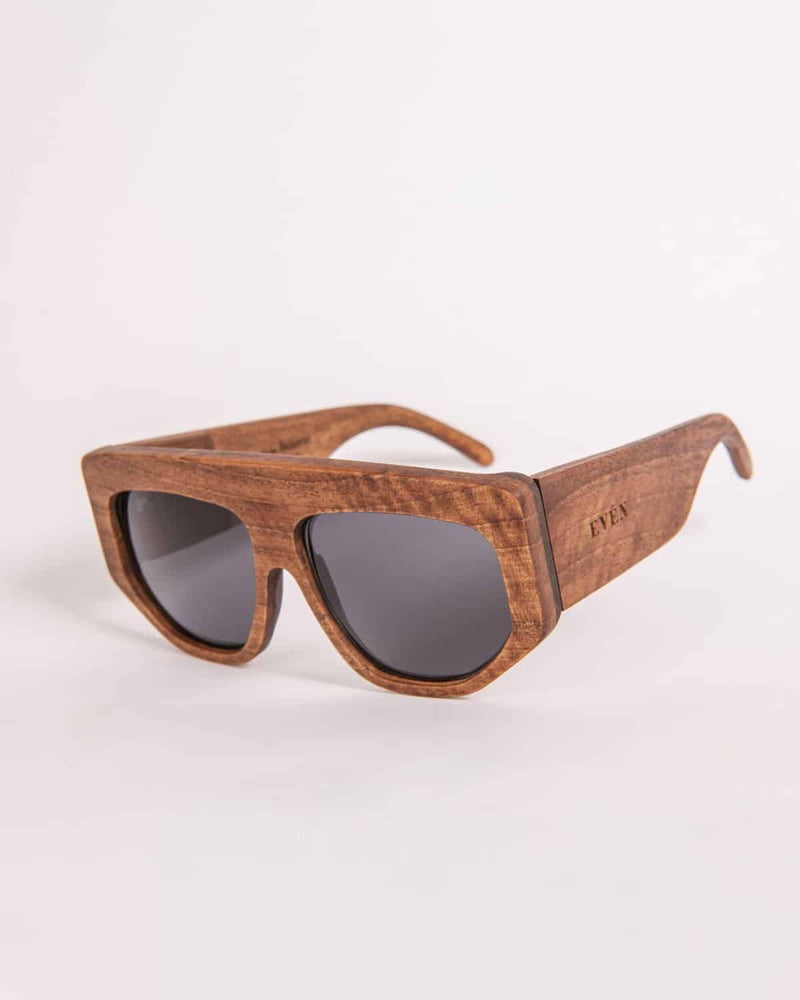 A pair of walnut wood sunglasses with dark polarized lenses and the brand name 'EVEN' engraved on the side.