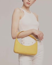 Video featuring model carrying zoe mini baguette bag in yellow leather by even online.