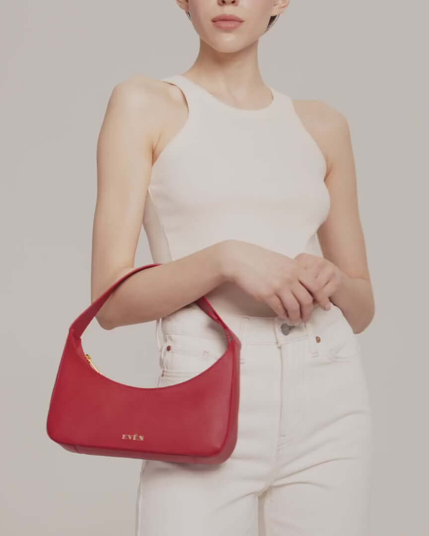 Video featuring woman wearing zoe red mini baguette bag by even online.