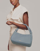 model is showcasing monna mini tote bag in light blue