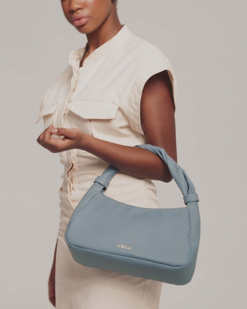 model is showcasing monna mini tote bag in light blue