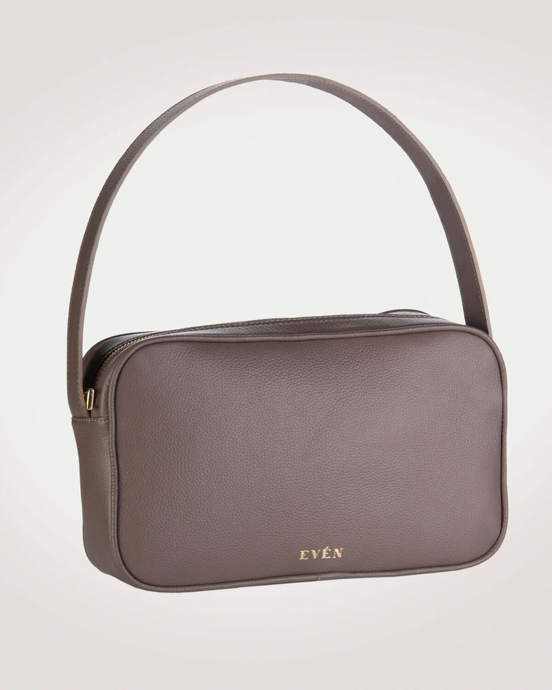 A taupe colored RHEA messenger bag with a sleek design and a brand logo visible on the front.