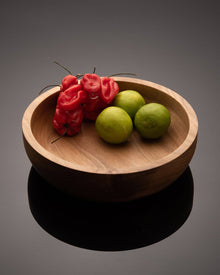 Fluit and vegetables in walnut wood bowl.