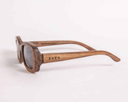 Handcrafted wooden sunglasses with EVEN logo engraved on temple, side view showing wood grain detail